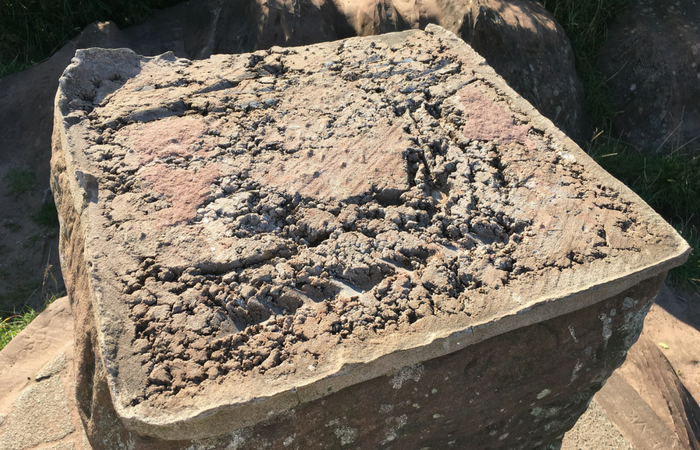 The top of the plinth at Thurstaston Hill viewing point, where the brass map has been crudely hacked away