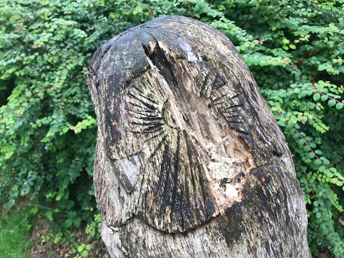 Damaged owl sculpture in Ashton Park