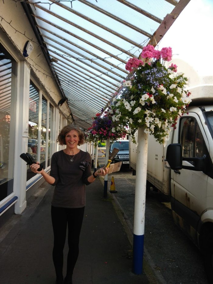 Members of West Kirby's small business owners' group tackle the weeding problem
