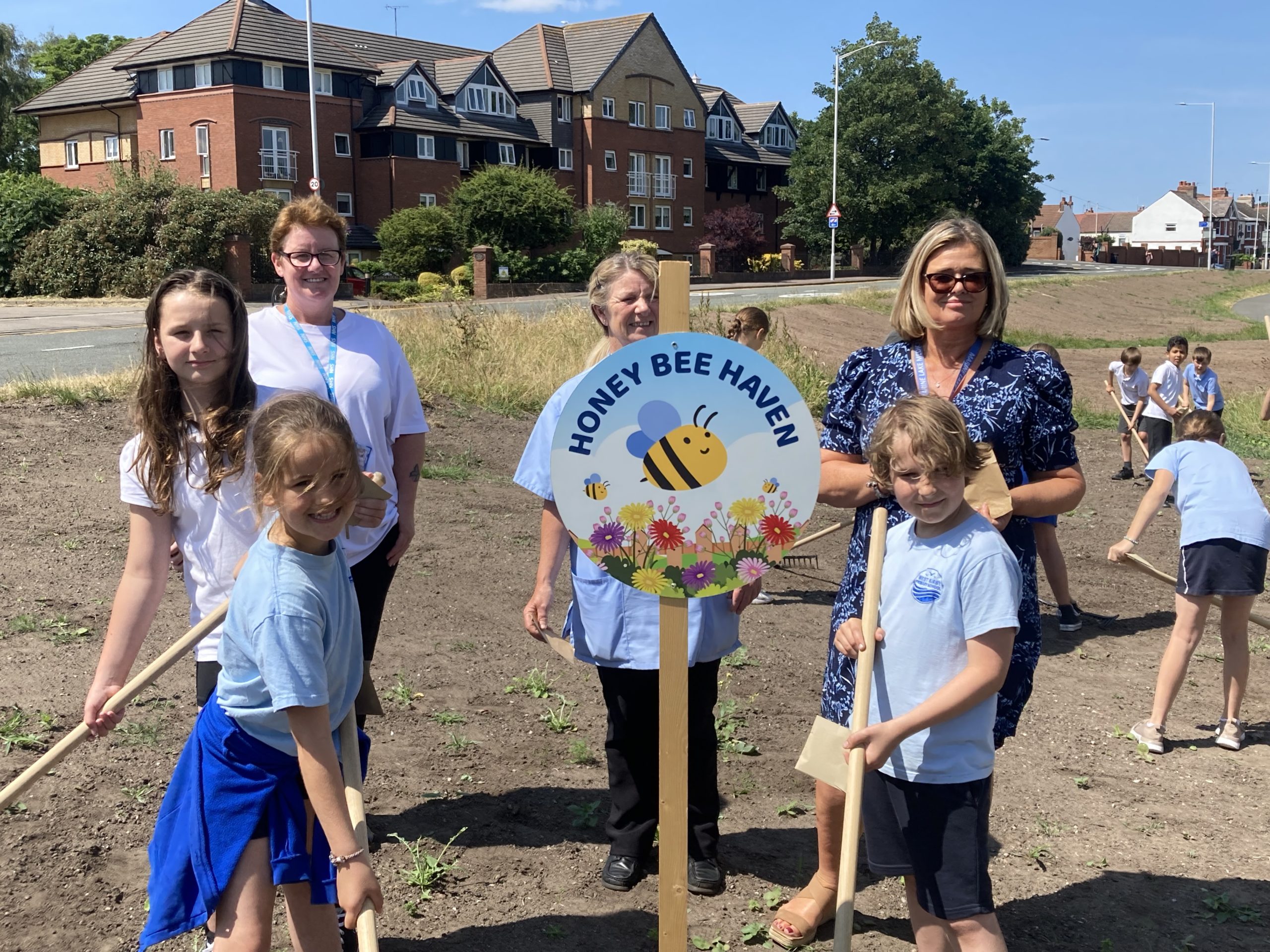 Pupils from West Kirby Primary School planting seeds with staff from Wirral Commmunity Health and Care NHS Foundation Trust